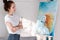 Beautiful woman holding paintbrush, happy looking enjoying picture, inspired drawing picture, girls with orange hair