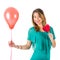 Beautiful woman holding red balloon and heart-shaped lollypop