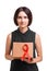 Beautiful woman holding the red ribbon, symbol of AIDS awareness isolated on a white background. World AIDS day concept.