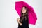 Beautiful woman holding umbrella and looking up