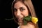 Beautiful woman holding yellow rose in her mouth