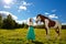 Beautiful woman with a horse in the field. Girl on