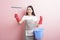 Beautiful woman housekeeper portrait on pink background