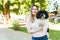 Beautiful woman hugging her dog at the park