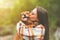 Beautiful woman hugging and kissing dog. Dog and owner together outdoors. Love and friendship between dog and owner