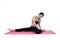 Beautiful woman indoor exercising using pink yoga mat