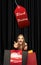 Beautiful woman inviting for shopping in black friday, sales concept. Vertical flyer, dark background