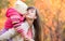 Beautiful woman with kid girl outdoor fall. Child kissing mo