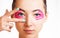 Beautiful woman with kinesiology tapes on eyelid.