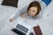 Beautiful woman with a laptop lies on the floor in the living room. Freelancer working at home indoors