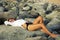 Beautiful woman laying on the beach rocks