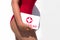 Beautiful woman lifeguard in a red swimsuit with a first aid kit on the white background