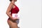 Beautiful woman lifeguard in a red swimsuit with a first aid kit on the white background