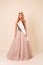 Beautiful woman with long blond hair in luxurious evening dress