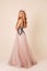 Beautiful woman with long blond hair in luxurious evening dress