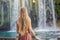 Beautiful woman with long hair on the background of Duden waterfall in Antalya. Famous places of Turkey. Apper Duden