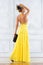 Beautiful woman in a long yellow dress.