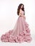 Beautiful woman in luxury lush pink dress. Fashion lady brunette