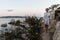 Beautiful woman in luxury summer dress enjoying peaceful seascape of Porto Rafael bay at Mediterranean sea of Costa