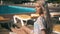 Beautiful woman lying on deck chair Young woman relaxes by the pool,video clip