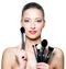 Beautiful woman with make-up brushes