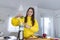 Beautiful woman making fruits smoothies with blender. Healthy eating lifestyle concept. Young woman preparing drink with bananas,