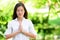 Beautiful Woman Meditating In Park