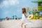 Beautiful woman on the miami beach. Girl walking barefoot on white sand of tropical island.