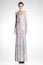 Beautiful woman model posing in long elegant silver sequins dress