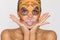 Beautiful woman with moisturizing leopard face mask. Mask with leopard, cat.