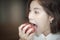 beautiful woman open wide mouth to bite the red apple