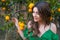 Beautiful woman outdoors at sunset in a orange orchard