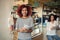 Beautiful woman owning coffee shop with friend feeling happy