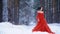 Beautiful woman with pale skin in a red dress with a raven on his shoulder