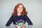 Beautiful woman with perfect red curly hair and make up in a funny winter knit sweater