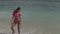 Beautiful woman in pink bikini at the beach