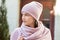 Beautiful woman in a pink knitted hat and scarf. Concept lifestyle, autumn, urban