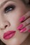 Beautiful Woman With Pink Nails and Luxury Makeup. Red Lips and Long Eyelashes