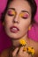 Beautiful woman in pink and yellow makeup - cosmetics focused beauty image