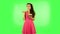 Beautiful woman with pleasure eating sweet white marshmallow while enjoying. Green screen