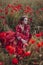 Beautiful woman in poppies field beauty portrait photoshoot