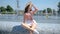 Beautiful woman posing next to city fountain in summer time