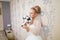 The beautiful woman posing in a wedding dress