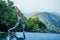 Beautiful woman practice yoga pose on the infinity pool above the mountain peak in the morning in front of beautiful