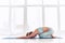 Beautiful woman practices yoga asana Balasana - child`s pose at the yoga studio