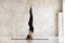 Beautiful woman practicing yoga, doing headstand exercise, salamba sirsasana