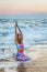 Beautiful woman practicing yoga in the sea