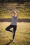 Beautiful woman praising yoga during obstacle course