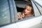 Beautiful woman preens in the car