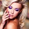 Beautiful woman with purple nails and glamour makeup